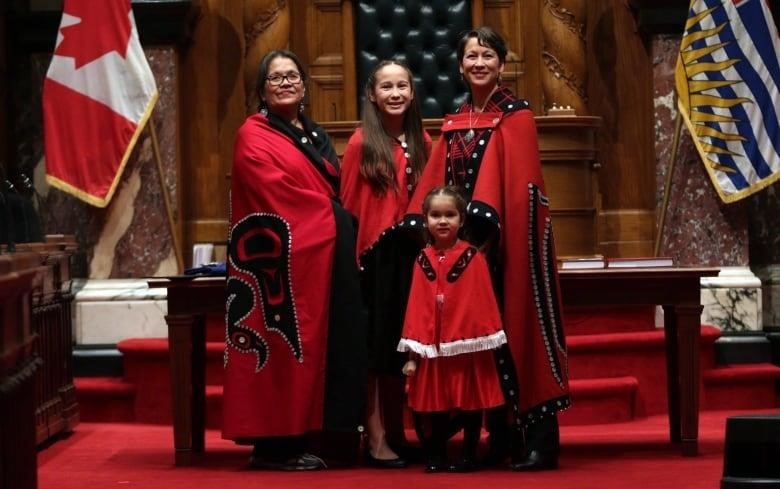 Melanie Mark, (far right), MLA elect for Vancouver-Mt Pleasant poses for a photo with her mother Yvonne, left, daughters Maya, 12, and Makayla, 5, after being sworn in as the first First Nations woman to serve in the B.C. legislature during a ceremony on Wednesday, February 17, 2016. THE CANADIAN PRESS/Chad Hipolito
