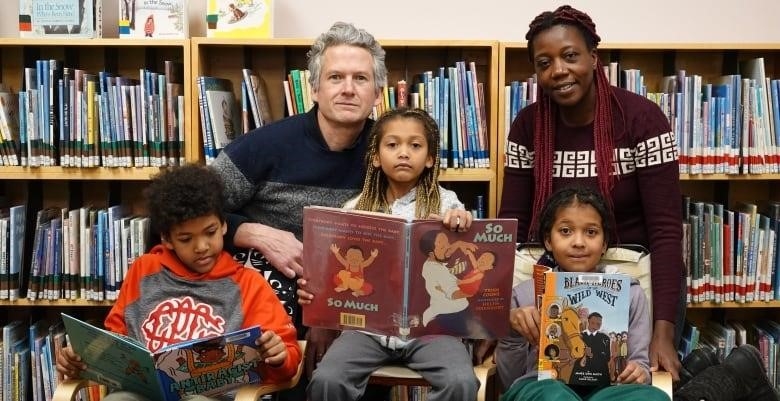 A family sits for a picture at the library.