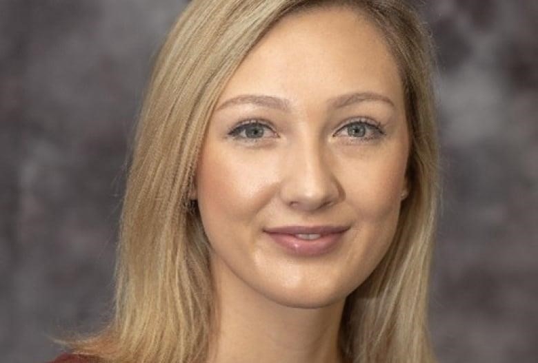 A woman poses for a headshot.