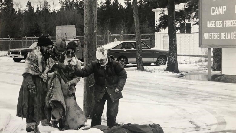 Four women pose as victims of nuclear war on a snowy day in Debert in this archival photo.