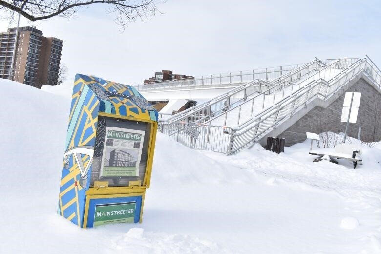 The Mainstreeter newspaper box, painted and refurbished by Tim Hunt, in its original spot near the Flora Footbridge.