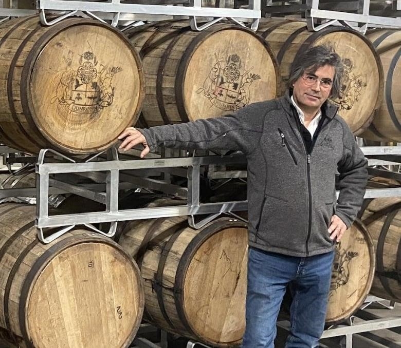 Mark Watson in front of barrels of spirits at Dunrobin Distilleries