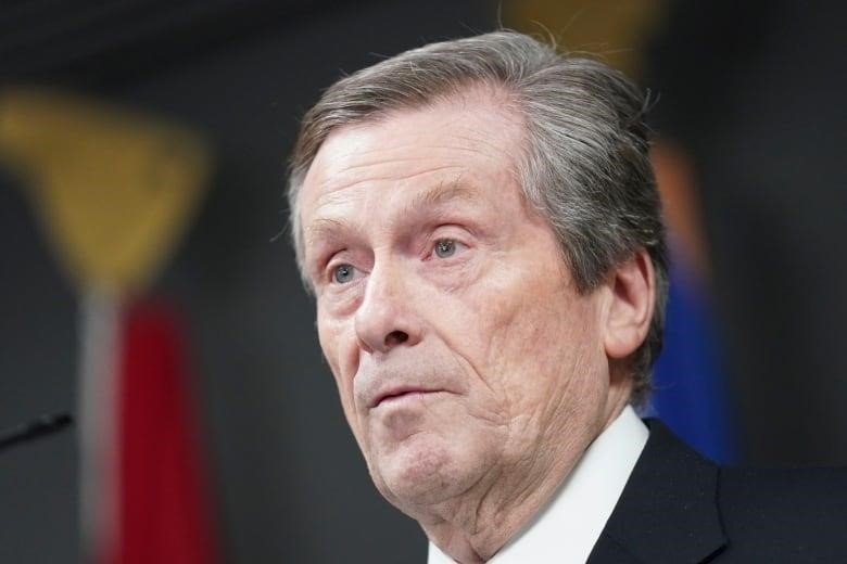 Close up of a grey haired man in a suit