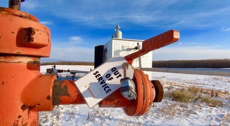 An "Out of Service" tag is attached to an orphan oil well.
