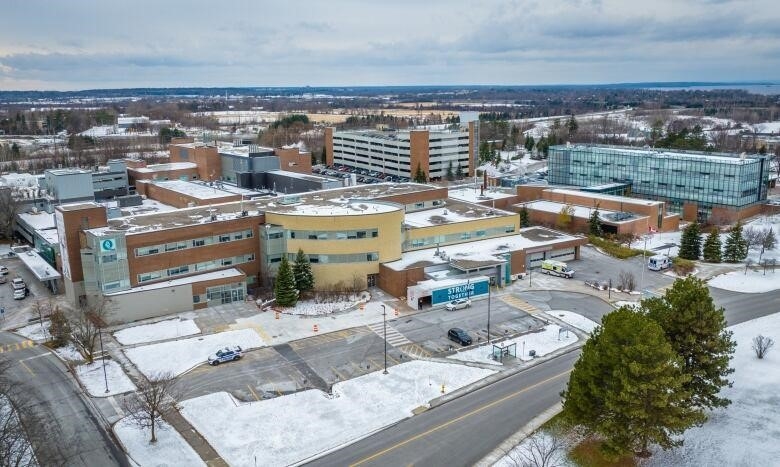 From above, a brick hospital building in a rural area.