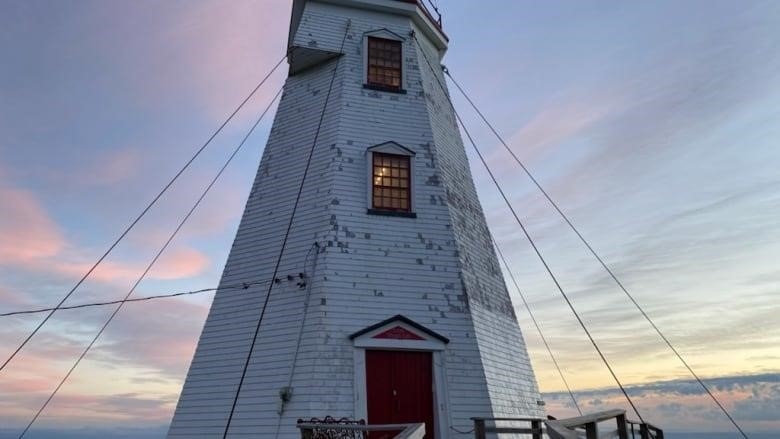 Swallowtail lighthouse with weathered shingles. 