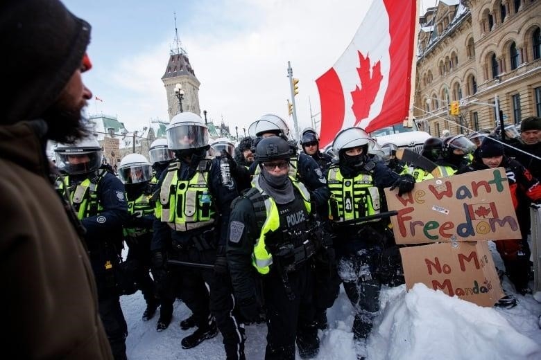 Police clear an area of protesters near Parliament Hill.
