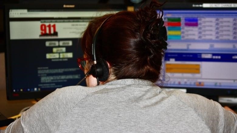 A 911 operator takes calls at her desk in Toronto Police's 911 communication centre.
