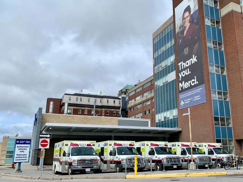 A photo of five ambulances lined up side by side outside the Civic hospital's emergency department.