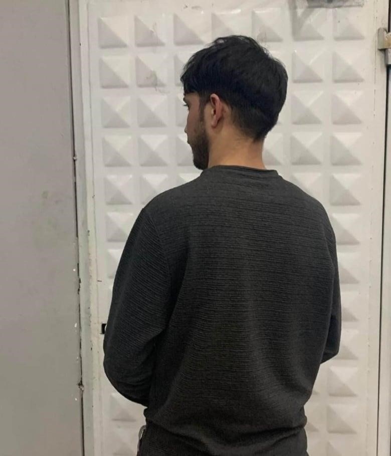 A back side of a man looking away.