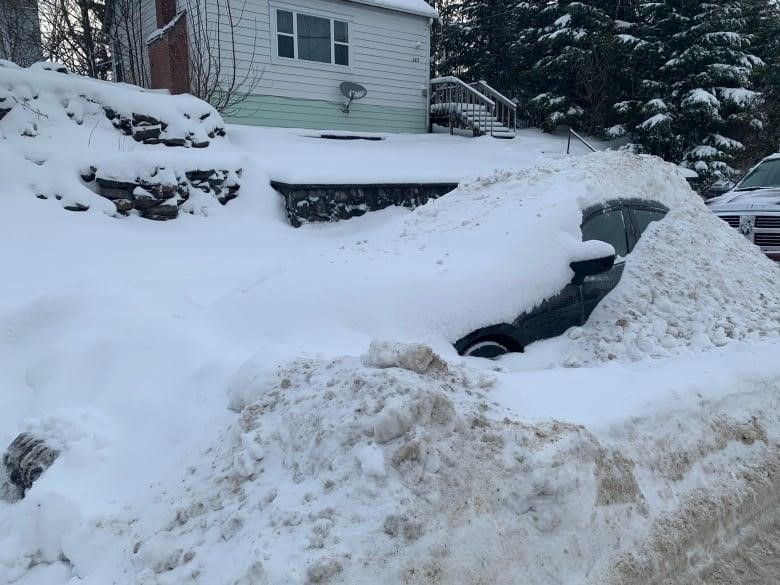 A car buried under snow.