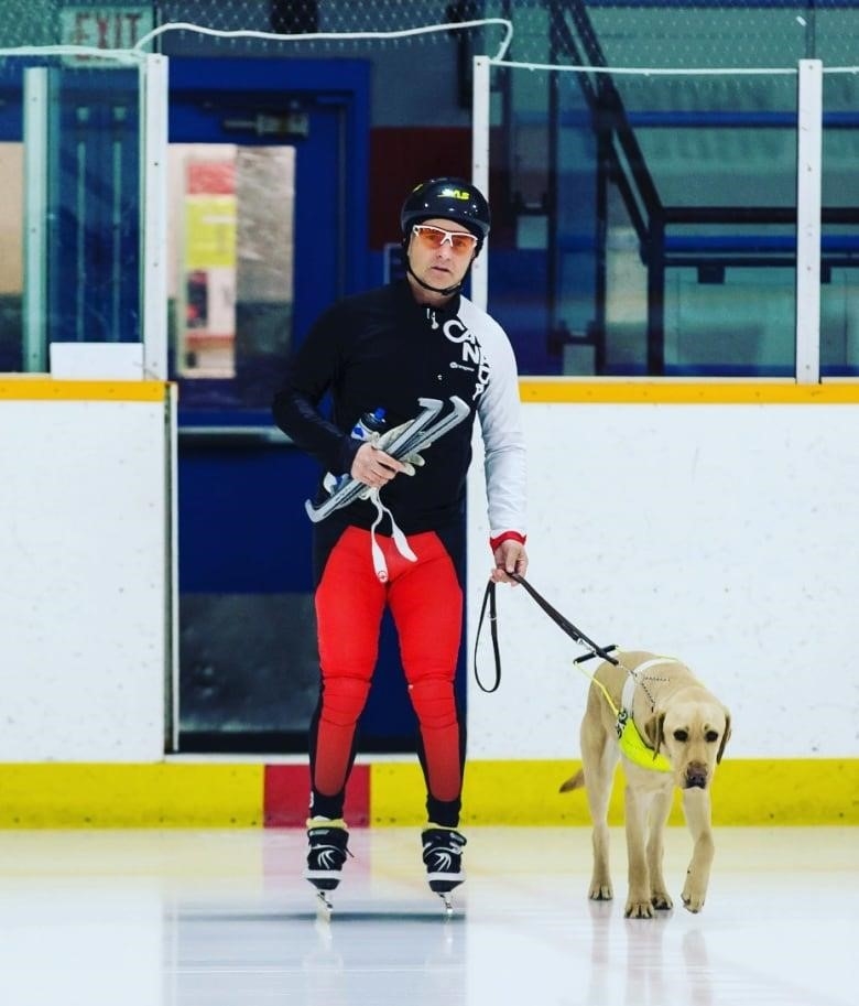 A man on speed skates with a dog on the ice.
