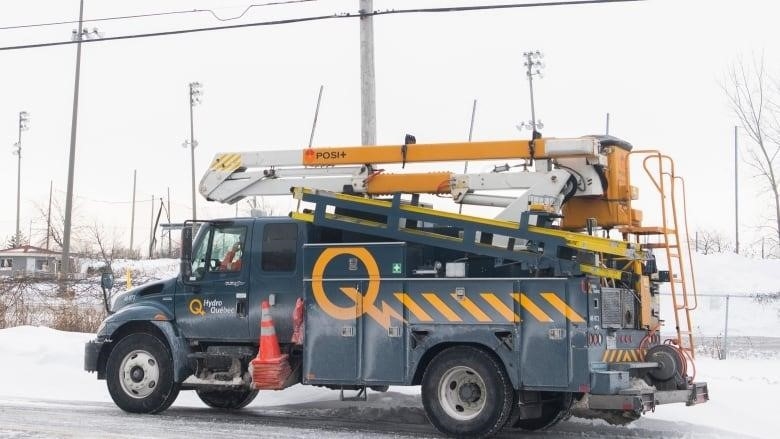 A Hydro-Québec truck is shown in an area without power in Montreal, Saturday, Dec. 24, 2022.