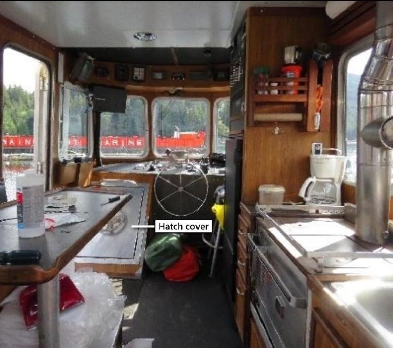 The wood-panelled interior of a small tug is pictured.