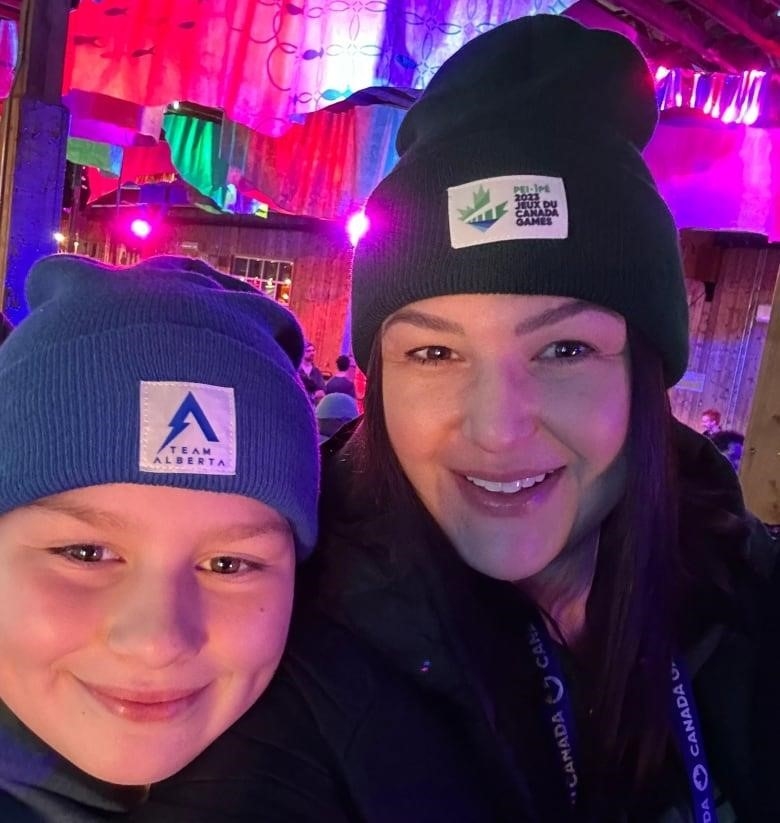 A selfie of a woman and a boy inside an arena.