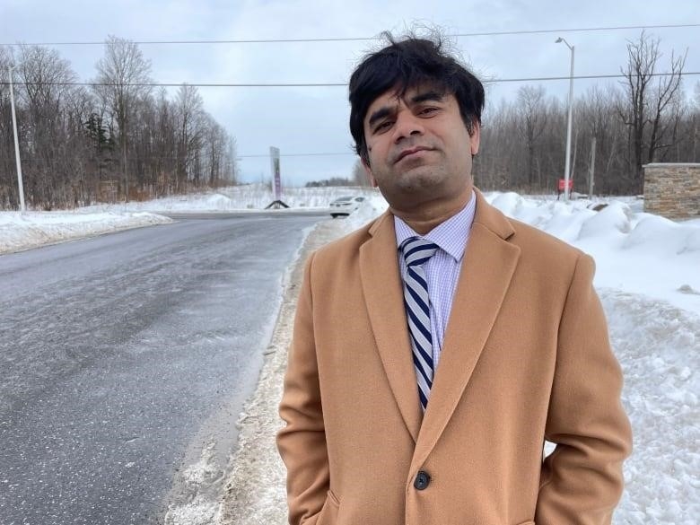 Kamal Hossein, a professor of civil engineering at Carleton University in Ottawa, stand at the corner of Greenbank Road and Cappamore Drive in the city's south end.