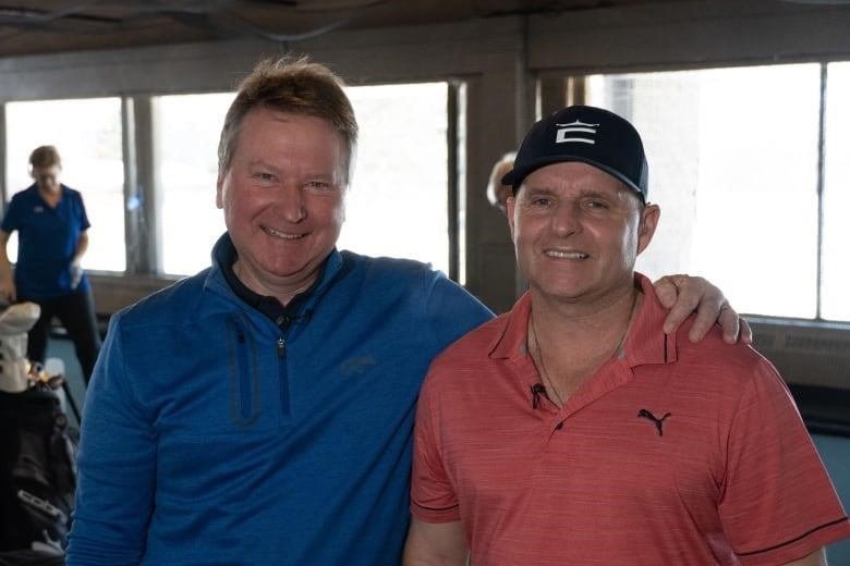 Two men at a golf course.