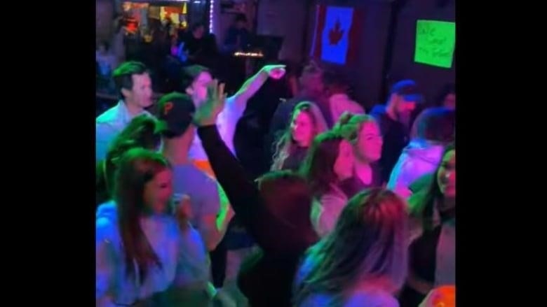 A number of people dance in a dark nightclub, as seen in a video still