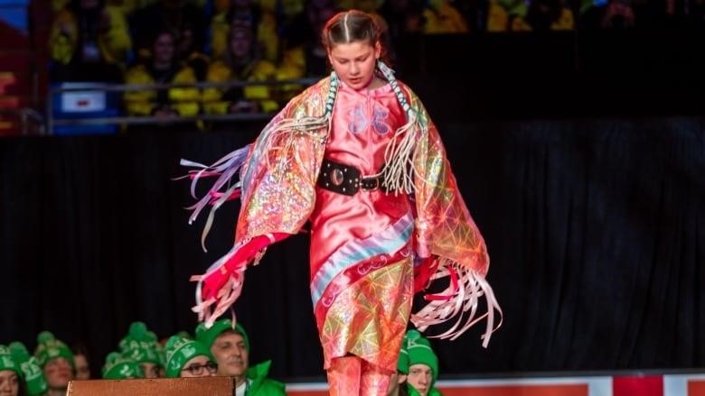 a dancer on stage in colourful regalia