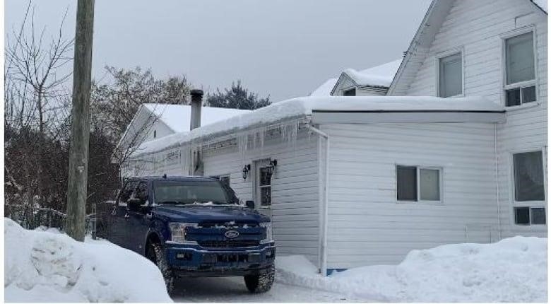 A house is covered in ice and snow.