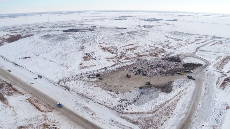 An aerial shot shows a vast, snow-covered field.