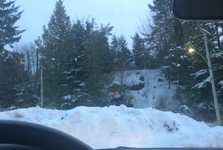 A kid on a snow pile.