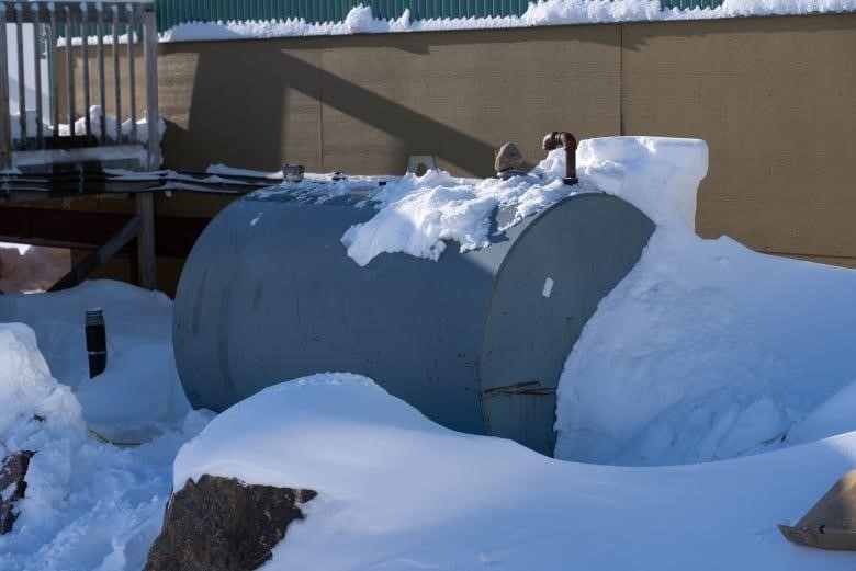 A fuel tank sits amid snow.