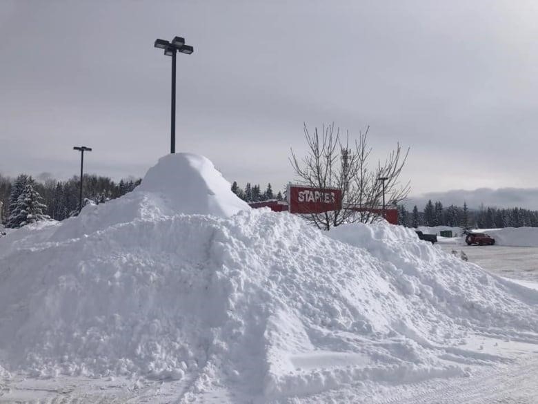 A pile of snow in front of a building.