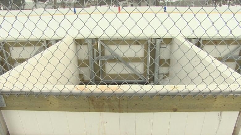 A penalty box at an outdoor rink in Steinbach, Man., is shown through a chain-link fence.