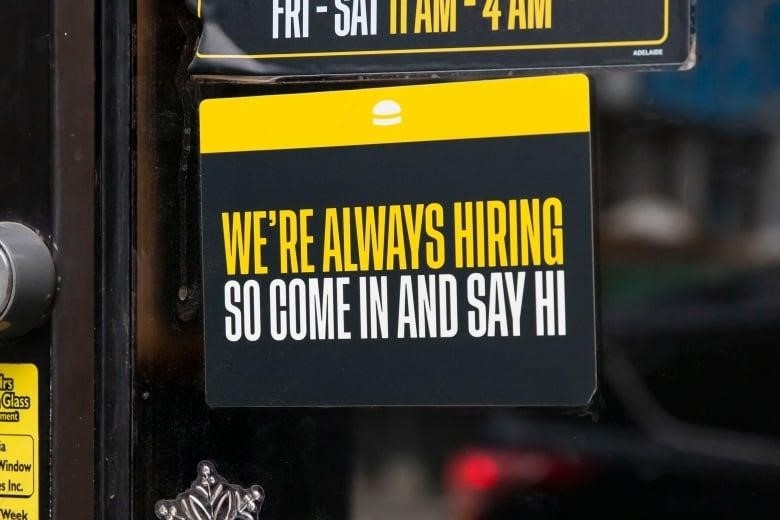 Sign in shop window reads in all capitals: 'We're always hiring so come in and say hi." 