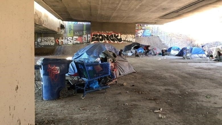 camping tents and recycling bags under the Ville-Marie Expressway