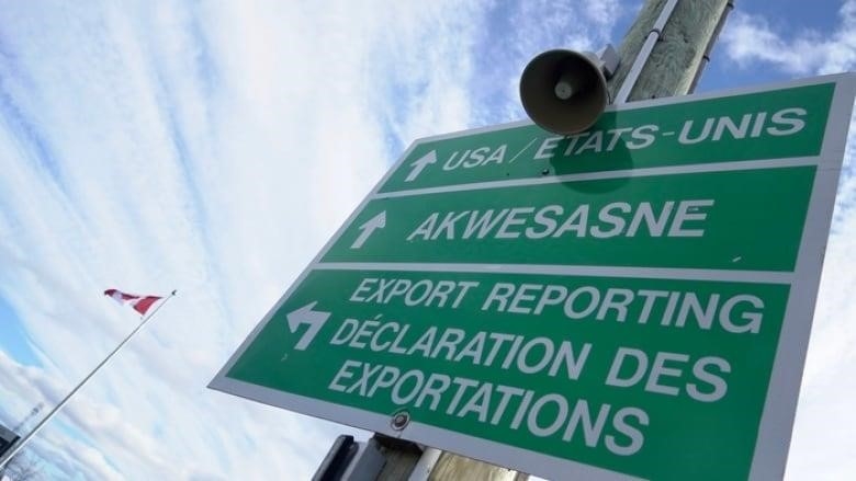 A road sign gives directions to communities near the Canada-U.S. border. 