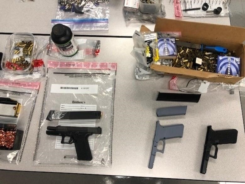 Confiscated illegal items are put on display by police including 3D printed guns.