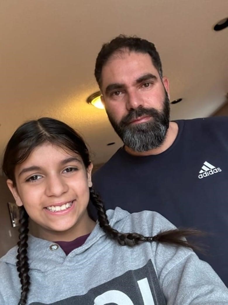 A selfie of a man with his 11-year old daughter. 