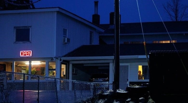 A roadside motel is seen in the twilight. 