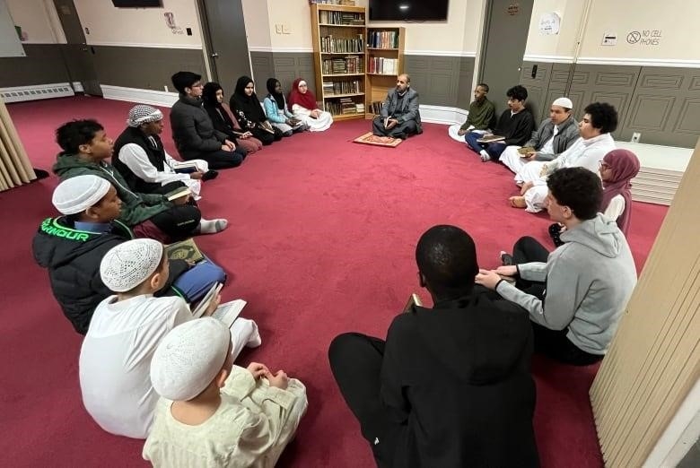 groups of students sitting on a carpet