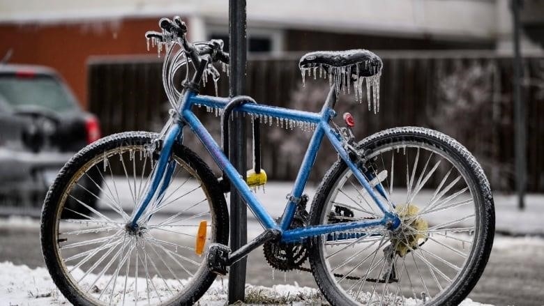 A bicycle is covered in ice.