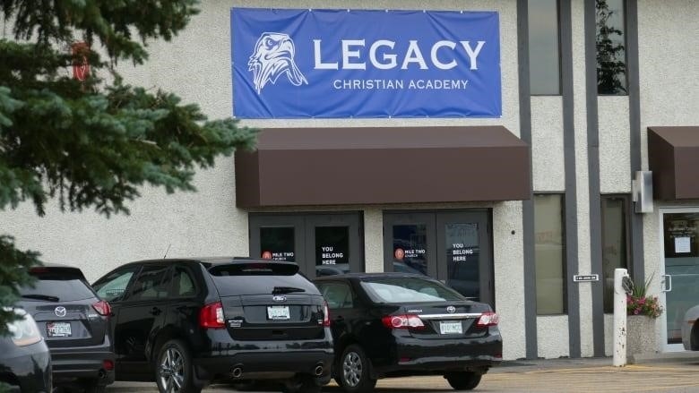 A blue banner that says "Legacy Christian Academy" adorns a building.