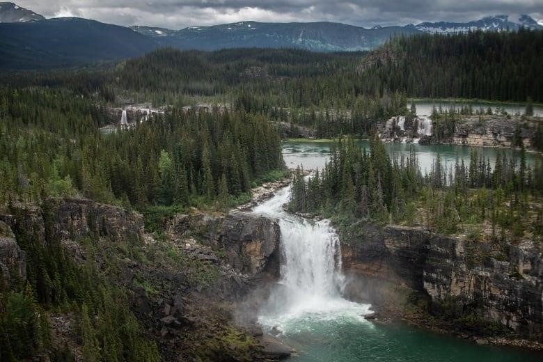 A waterfall surrounded by foothills. 