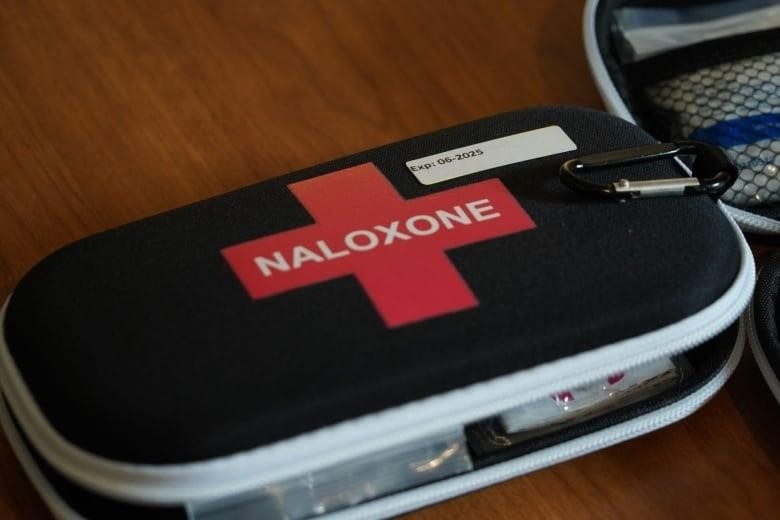 A Naloxone kit sits on a table. 