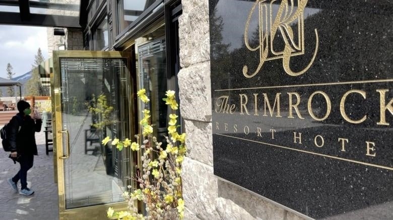 A person walks into the Rimrock Resort Hotel in Banff, Alta.