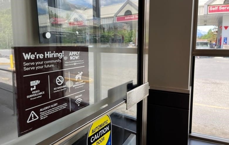 A "We're Hiring" sign is pictured at a Tim Hortons restaurant in Canmore, Alberta. 