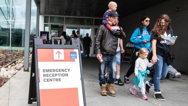 Family walking outside Emergency Reception Centre Edmonton 2023 wildfires