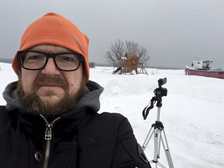 A man takes a selfie in the snow.
