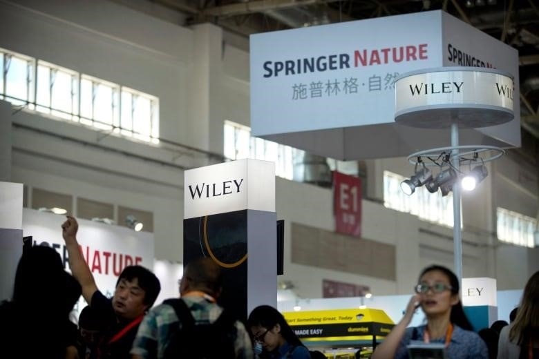 Signs in English and Chinese are displayed at a trade publishing event. 