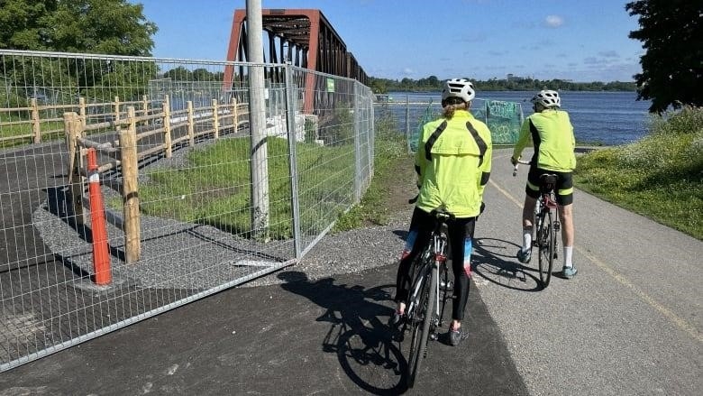 cyclists gazing at Ottawa end of Chief William Commanda Bridge, July 22, 2023