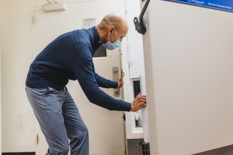 A man opens a freezer