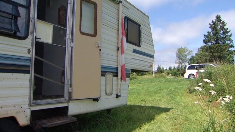 A camper trailer is shown in a field