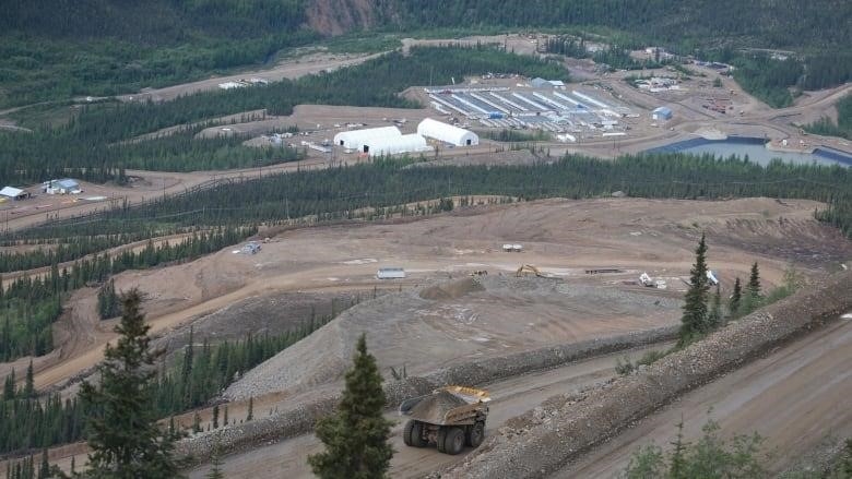 Looking down on a remote mine site from a hill.