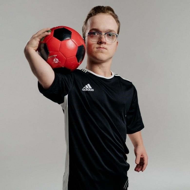 A man holding a soccer ball. 